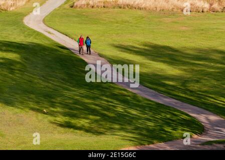 Bretton Woods, New Hampshire, USA -- September 25, 2016. A couple walks on the path of a golf course in historic Bretton Woods, NH. Stock Photo