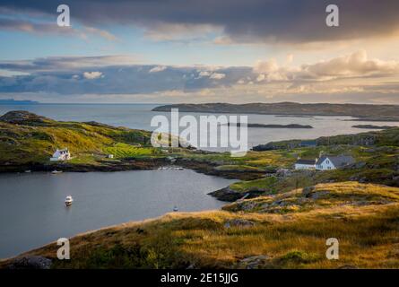 South Harris, Isle of Lewis and Harris, Scotland: Clearing evening storm clouds over an isolated coastal village Stock Photo