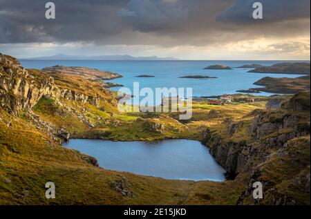 South Harris, Isle of Lewis and Harris, Scotland: Clearing evening storm clouds over an isolated coastal village Stock Photo