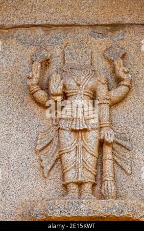 Hampi, Karnataka, India - November 4, 2013: Hazara Rama Temple. Closeup of beige stone sculptures of decapitated Vishnu. Stock Photo