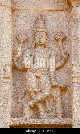 Hampi, Karnataka, India - November 4, 2013: Hazara Rama Temple. Closeup of beige stone sculptures of Vishnu as Rama. Stock Photo