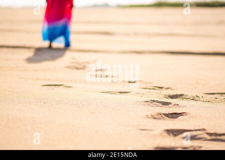 foot print of a lady walking on a beach with focus on a section of her foot prints Stock Photo