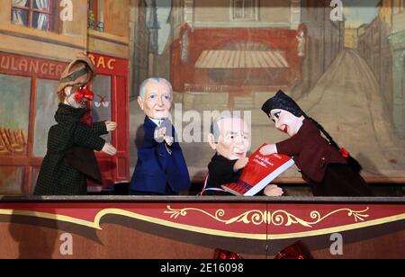 A new hand puppet with the head of Lyon's senator-mayor Gerard Collomb in the puppet theater La maison de Guignol , he is depicted with his last book 'et si la France s'eveillait' with traditional Lyon puppets Guignol and Gnafron and OL's Manager Jean Michel Aulas in Lyon, France April 16,2011. Photos by Vincent Dargent/ABACAPRESS.COM Stock Photo