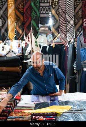 Sanli Urfa, Turkey: September 12 2020: Street vendor selling Middle Eastern men's scarf Stock Photo