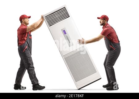 Workers in uniforms installing a self standing portable air conditioning unit isolated on white background Stock Photo