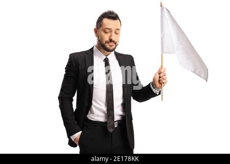 Disappointed businessman holding a white flag isolated on white background Stock Photo