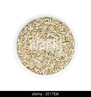 Fennel seeds in round bowl isolated over white background. Top view Stock Photo