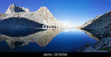 reflection of Mount Mendel and Gould in lake in Darwin Canyon of Kings Canyon National Park in the Sierra Nevada Mountains of California Stock Photo