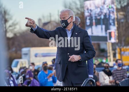 Atlanta, United States. 04th Jan, 2021. President-Elect Joe Biden addresses crowd at a drive-in rally on the eve of Georgia's Senate runoff election at Center Parc Credit Union Stadium on January 4, 2021 in Atlanta, Georgia. Credit: Sanjeev Singhal/The News Access/Alamy Live News Stock Photo
