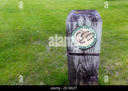 Mackinaw City, Michigan, USA - May 29, 2020: Trail marker for the Mackinaw City Historical Pathway. The two mile trail features landmarks and displays Stock Photo
