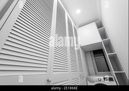 White laundry space inside wardobe room in new apartment Stock Photo