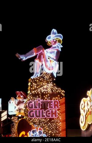Colorful neon sign for Glitter Gulch casino depicts a cowgirl on Fremont Street in Las Vegas, Nevada.