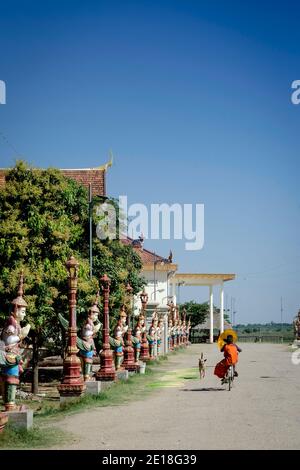 buddhist monk street scene walking outside Wat Svay Andet Pagoda UNESCO site in Kandal Province Cambodia Stock Photo