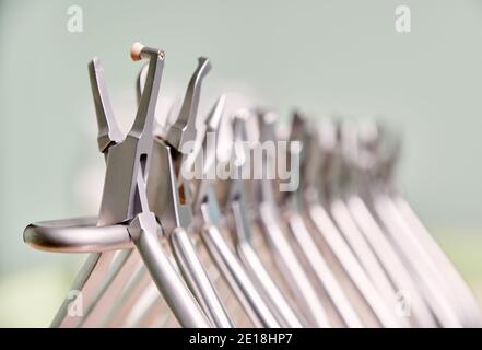 Close up view of set of various stainless steel instruments for braces in dental clinic. Concept of dentistry, orthodontics and medical instruments. Stock Photo