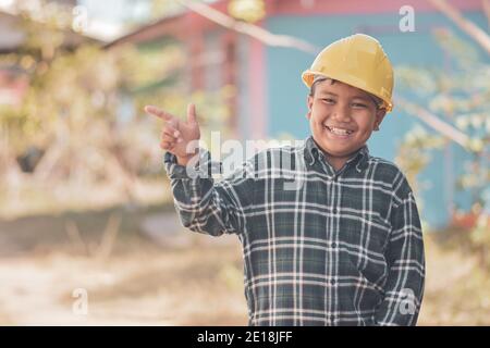 Boy kid Yellow helmet hard hat safety Engineering concept Stock Photo