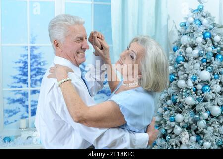 Happy senior couple on Christmas at home dancing Stock Photo