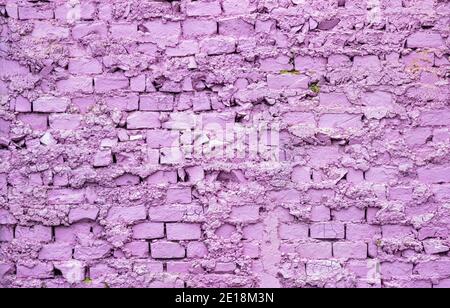 Background from an old and worn brick wall painted in purple Stock Photo