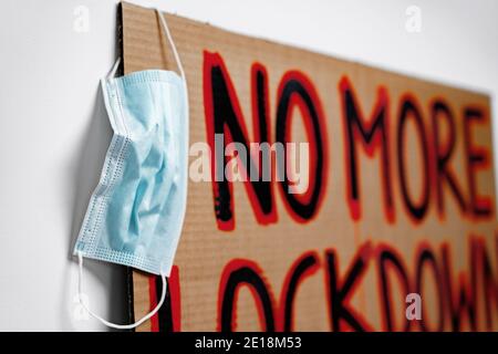 Protestive placard against coronavirus lockdowns against wall Stock Photo