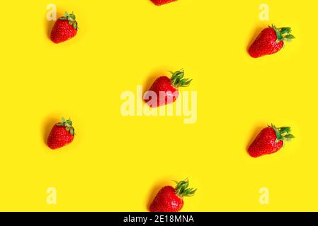 Abstract background with red fresh strawberryes on yellow background. Seamless pattern Stock Photo