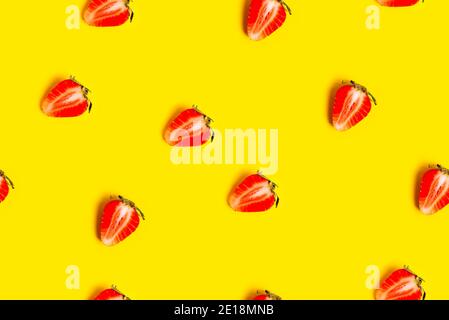Abstract background with red fresh strawberryes on yellow background. Seamless pattern Stock Photo