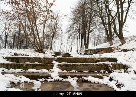 Stone concrete snow covered stairs in the city at winter. Stairway to heaven. Black and white Stock Photo