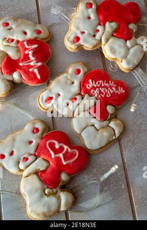 Teddy bears shaped cookies with icing heart decorations. Stock Photo