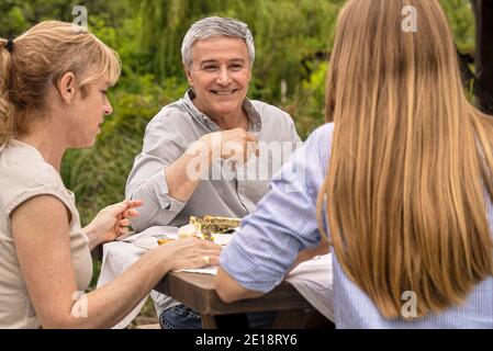 Family having lunch in garden Stock Photo