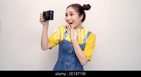 Woman using photo camera in studio Stock Photo