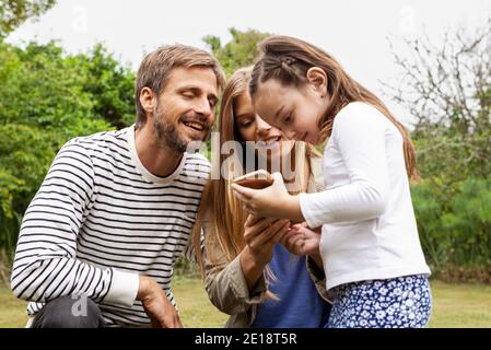 Happy family using smartphone Stock Photo