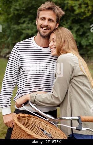 Smiling mid adult couple embracing in garden Stock Photo