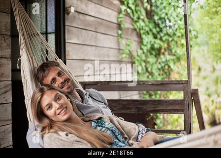 Portrait of couple relaxing in hammock Stock Photo