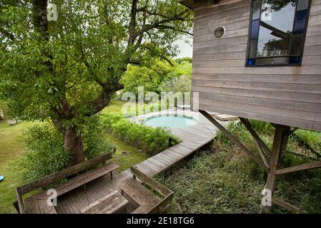 View of stilt hut and garden Stock Photo