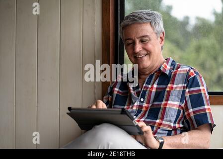 Senior man using digital tablet Stock Photo