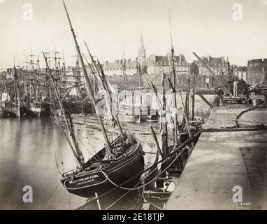 Vintage 19th century photograph - view of the harbour at St Malo, France. Ships tied up aalong the dock. Stock Photo