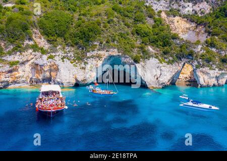 Daily excursion boat with tourists, in secluded beach in Paxoi island. Stock Photo