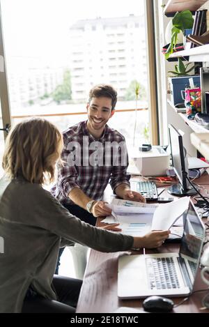 Business people reviewing documents in office Stock Photo