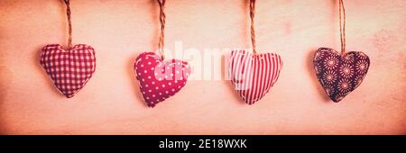 Four red fabric hearts on vintage panoramic background with copy space Stock Photo