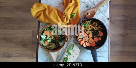 Salad bowl with carrots, olives, and tofu eggs Stock Photo