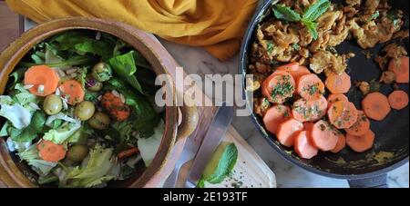 Salad bowl with carrots, olives, and tofu eggs Stock Photo