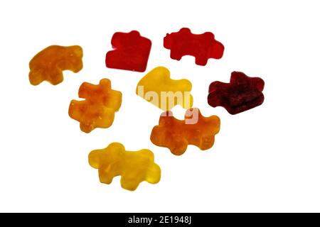 Multicolored chewy figured marmalade in the form of puzzles isolate on a white background close-up. Stock Photo