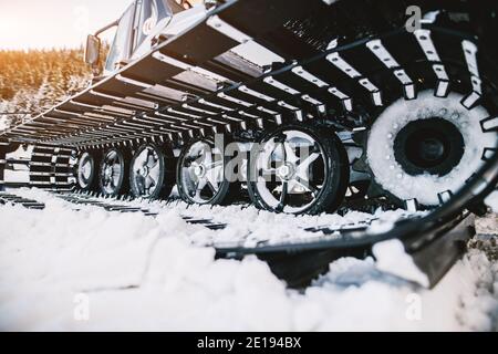 Close up view of special snow vehicle with the caterpillar on the snow in winter. Stock Photo