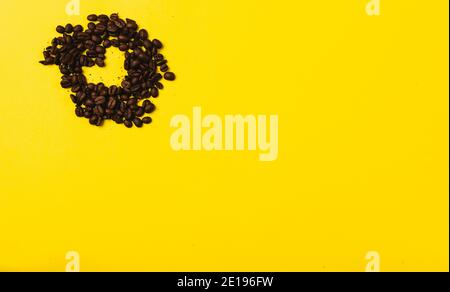 Coffee beans in the shape of a heart on a illuminating background with empty space where your ad could be. St Valentines Stock Photo