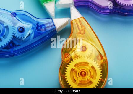 Multi-colored Stationery correction tapes on a blue background. Free space. The view from the top Stock Photo