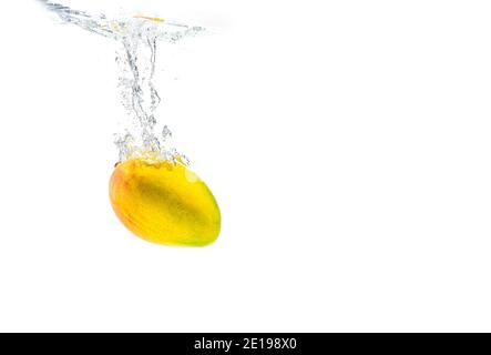 Mango sinking in water isolated on white Stock Photo