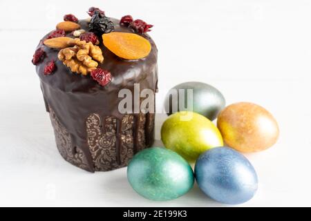 Easter cake and colored eggs on white background. Holiday food and easter concept. Stock Photo