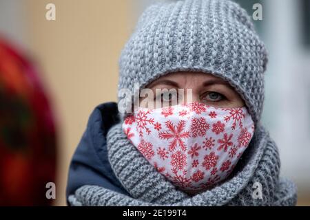 Kaluga, Russia. 2nd of January, 2021 A woman wearing a face protective mask walks down a street in the center of Kaluga city, Russia Stock Photo