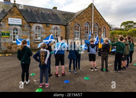 School children celebrate St Andrew's Day with a ceremony, Athelstaneford, East Lothian, Scotland, UK Stock Photo