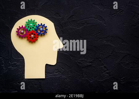 Brain model of gears and cogs on the paper head, top view Stock Photo