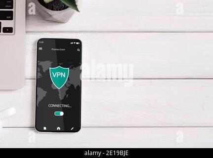 Smartphone with vpn app lying on the table Stock Photo