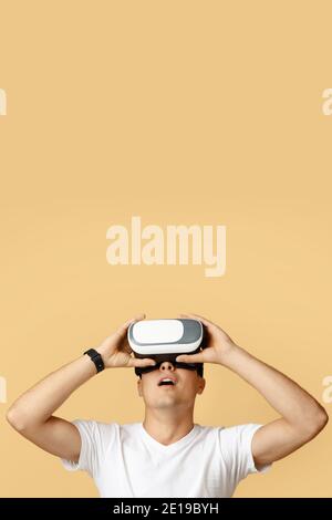 Vr gadget for entertainment and work. Shocked european millennial male with open mouth in virtual reality glasses Stock Photo
